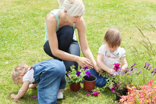 Gardener assessing a larger suburban garden for a free quote in Chessington